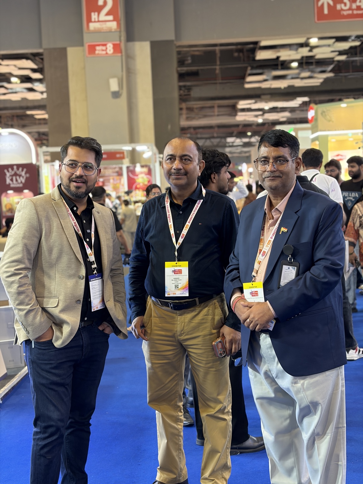 Sudhir Makhija walking the exhibition floor in conversation