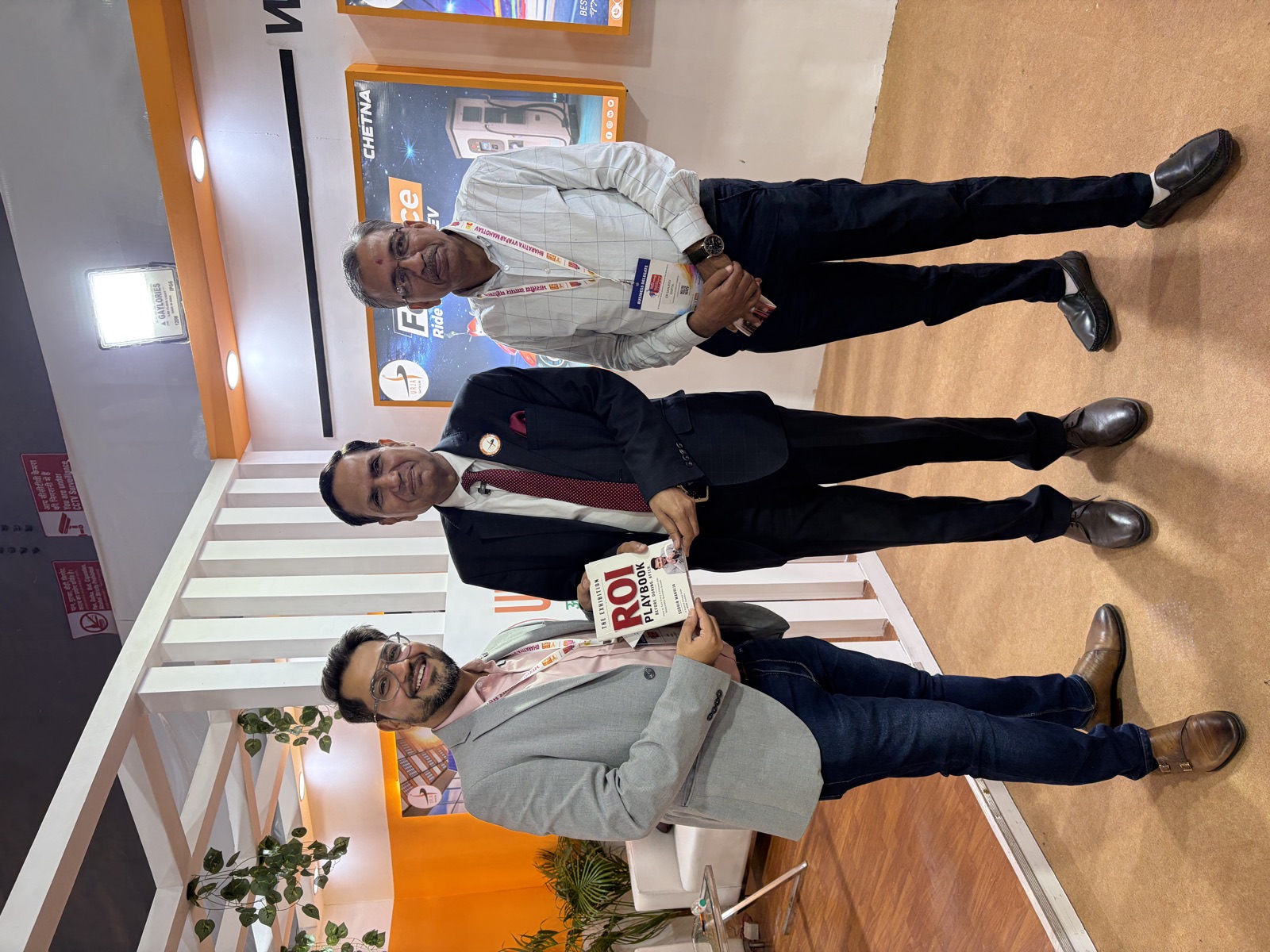 Sudhir Makhija presenting an early copy of The Exhibition ROI Playbook to founders